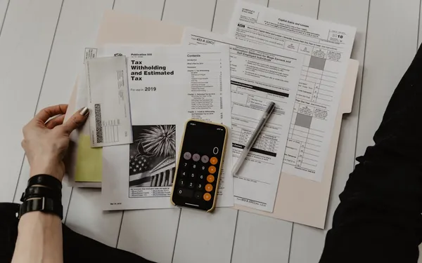 Calculator and financial documents representing pricing strategy