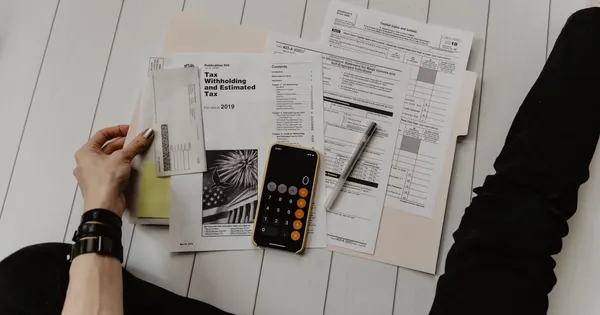 Calculator and financial documents representing pricing strategy